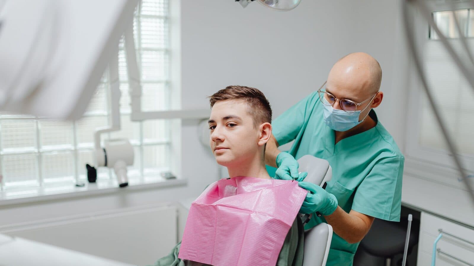 A relaxed young patient in the chair as the dentist prepares to begin