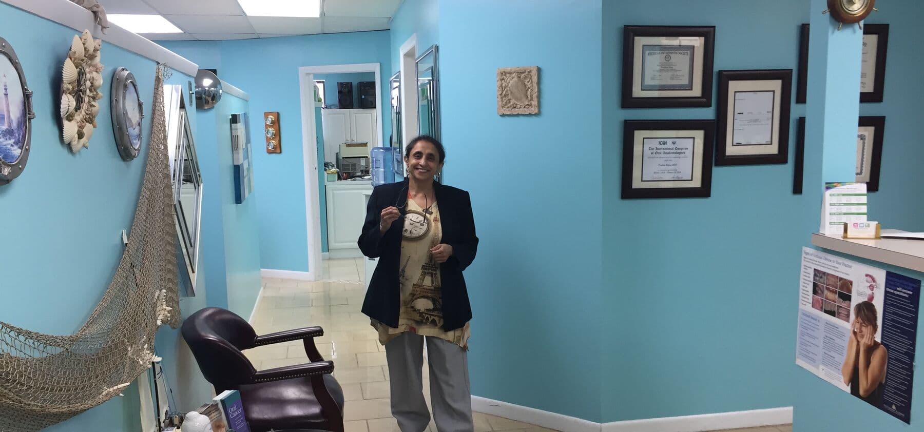 Hallway inside Tender Dental Care with Dr. Raju and her framed credentials